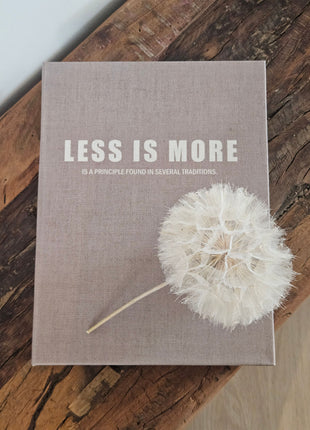 Opbergboek Less is More met lichtgrijze stoffen kaft en witte letters op een witte ondergrond