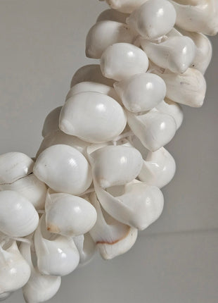 Close-up van schelpenketting natuurlijk wit - gevlochten band en volle structuur