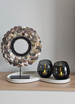 Decoratie Set Ivory Elite met een ketting van rondgepolijste schelpen en twee grijze Moho waxinelichthouders op een ivoor dienblad.